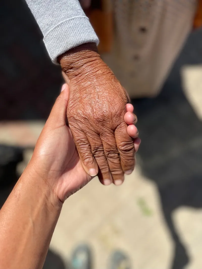 Caregiver holding hands with elderly patient